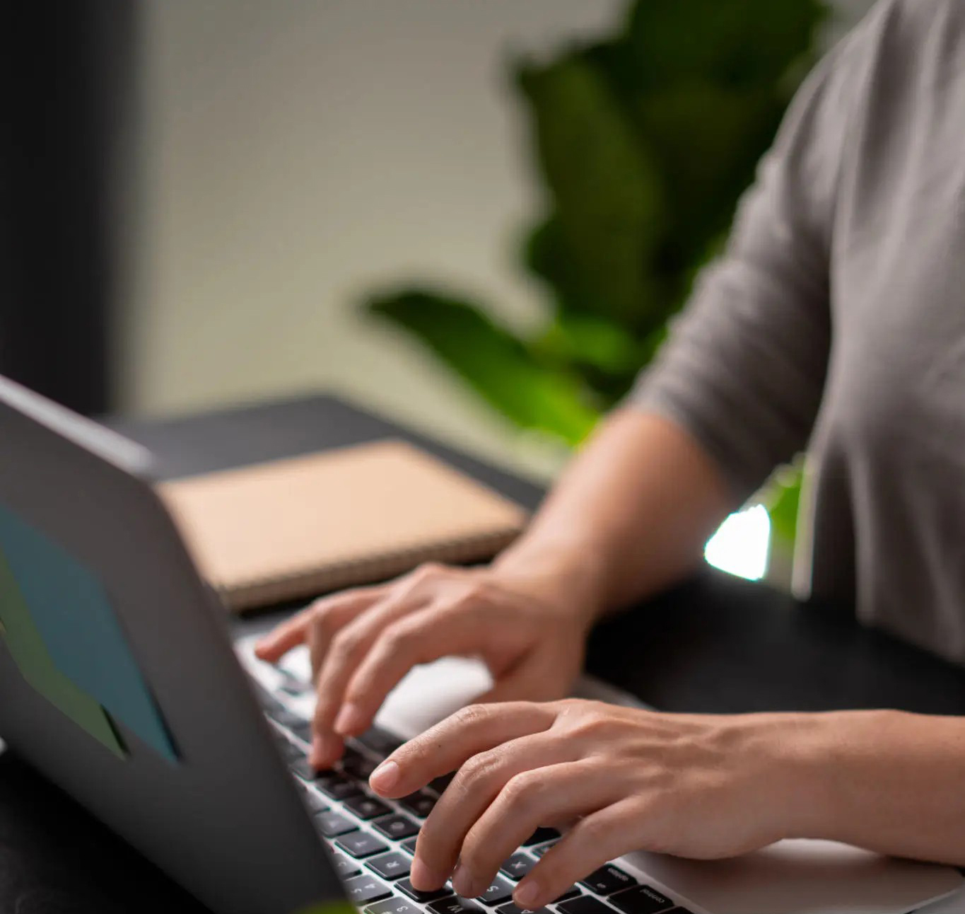 Hands typing on laptop with financial data